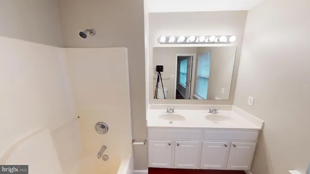 an empty room with wooden floor and a window