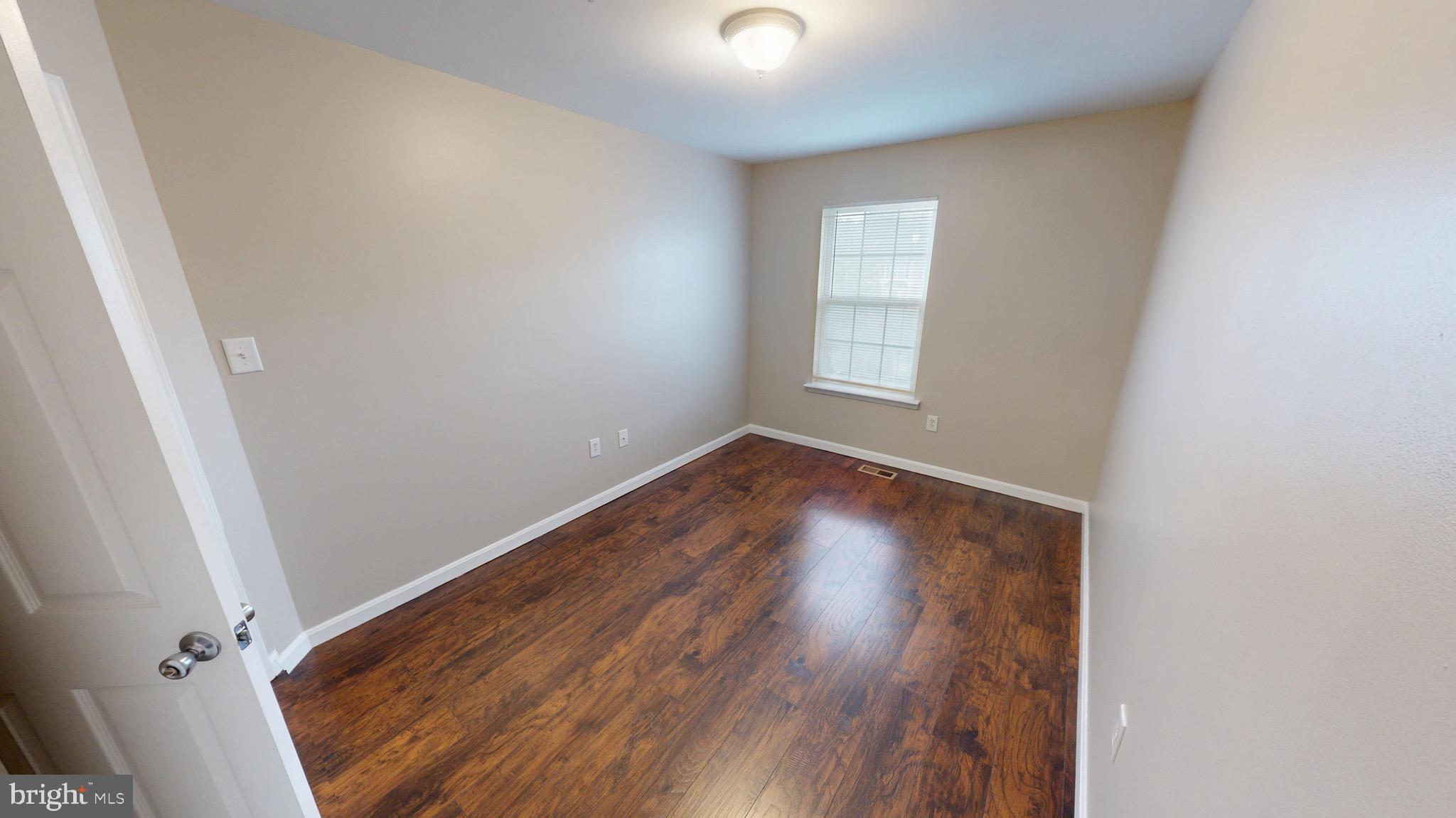10611 Riva Place White Plains, MD 20695 - Photo 47 of 93 an empty room with wooden floor and windows