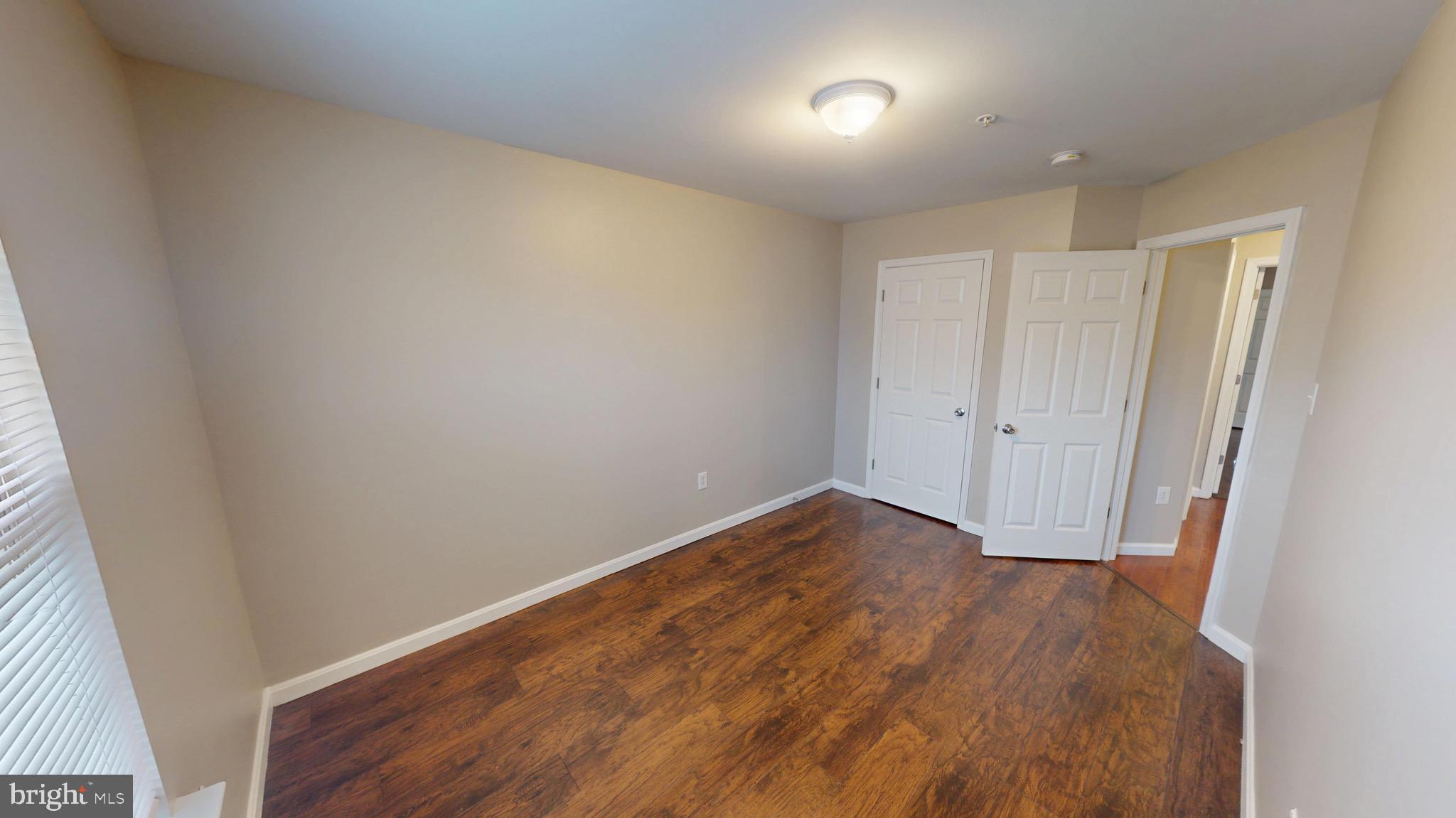 10611 Riva Place White Plains, MD 20695 - Photo 48 of 93 an empty room with wooden floor and closet