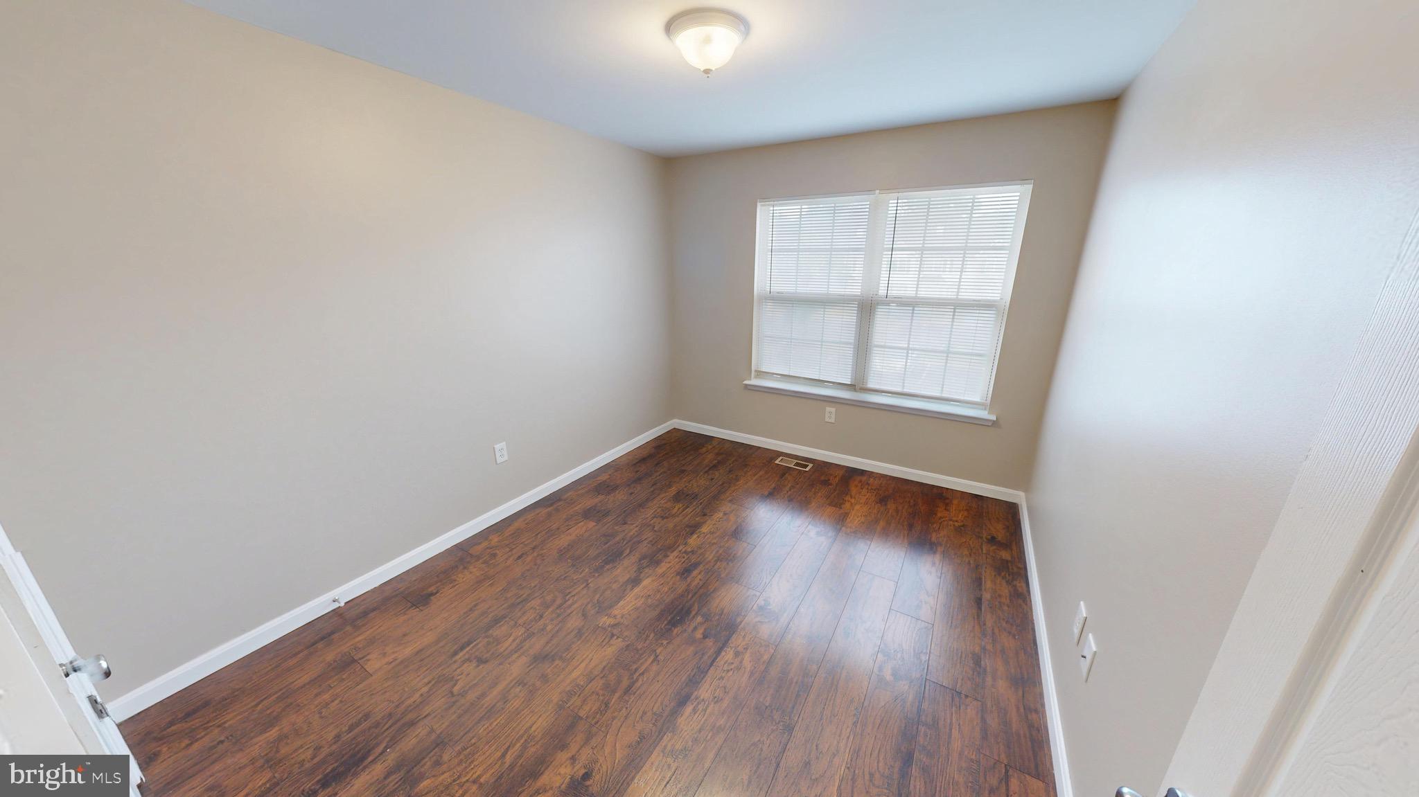 10611 Riva Place White Plains, MD 20695 - Photo 50 of 93 an empty room with wooden floor and windows