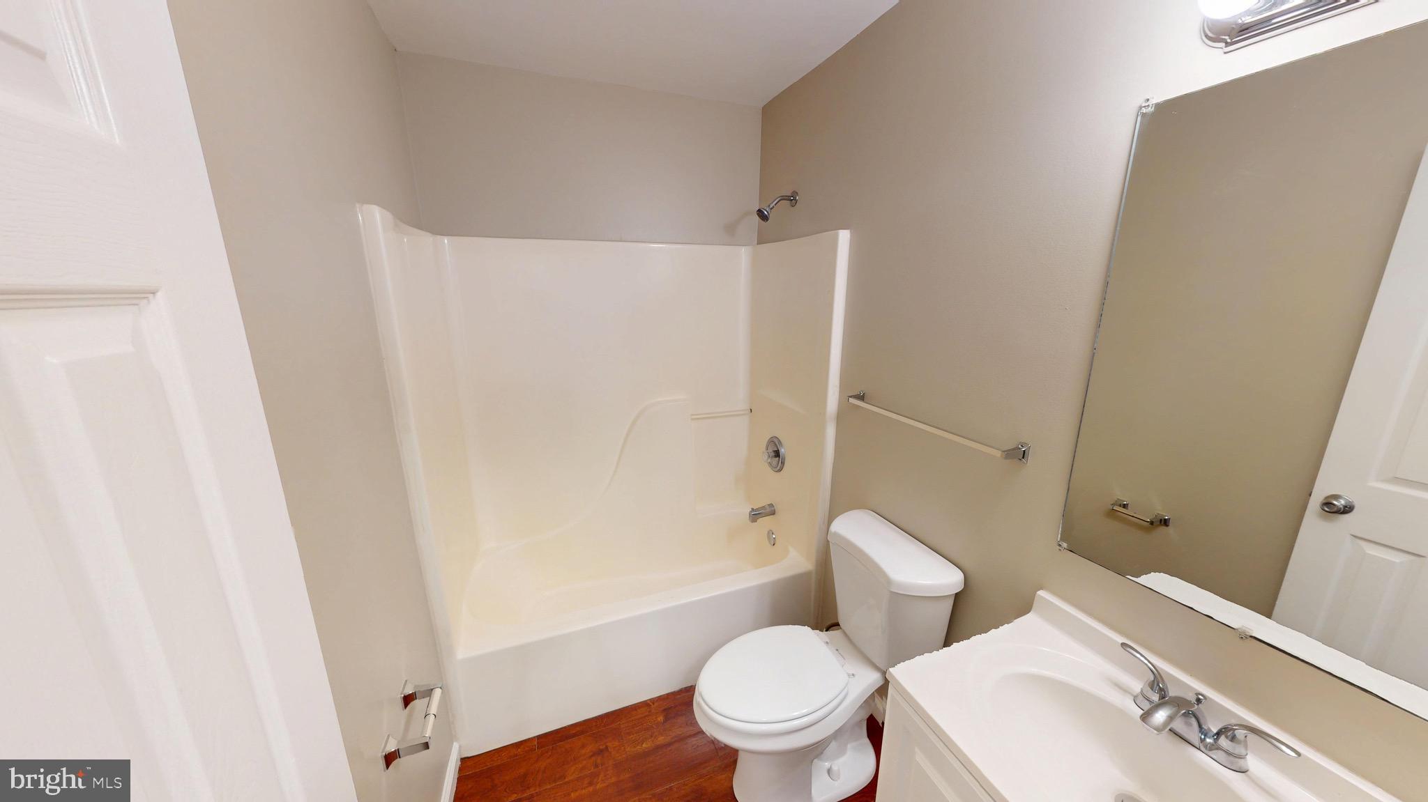 10611 Riva Place White Plains, MD 20695 - Photo 56 of 93 a white toilet sitting next to a bathroom sink and a shower