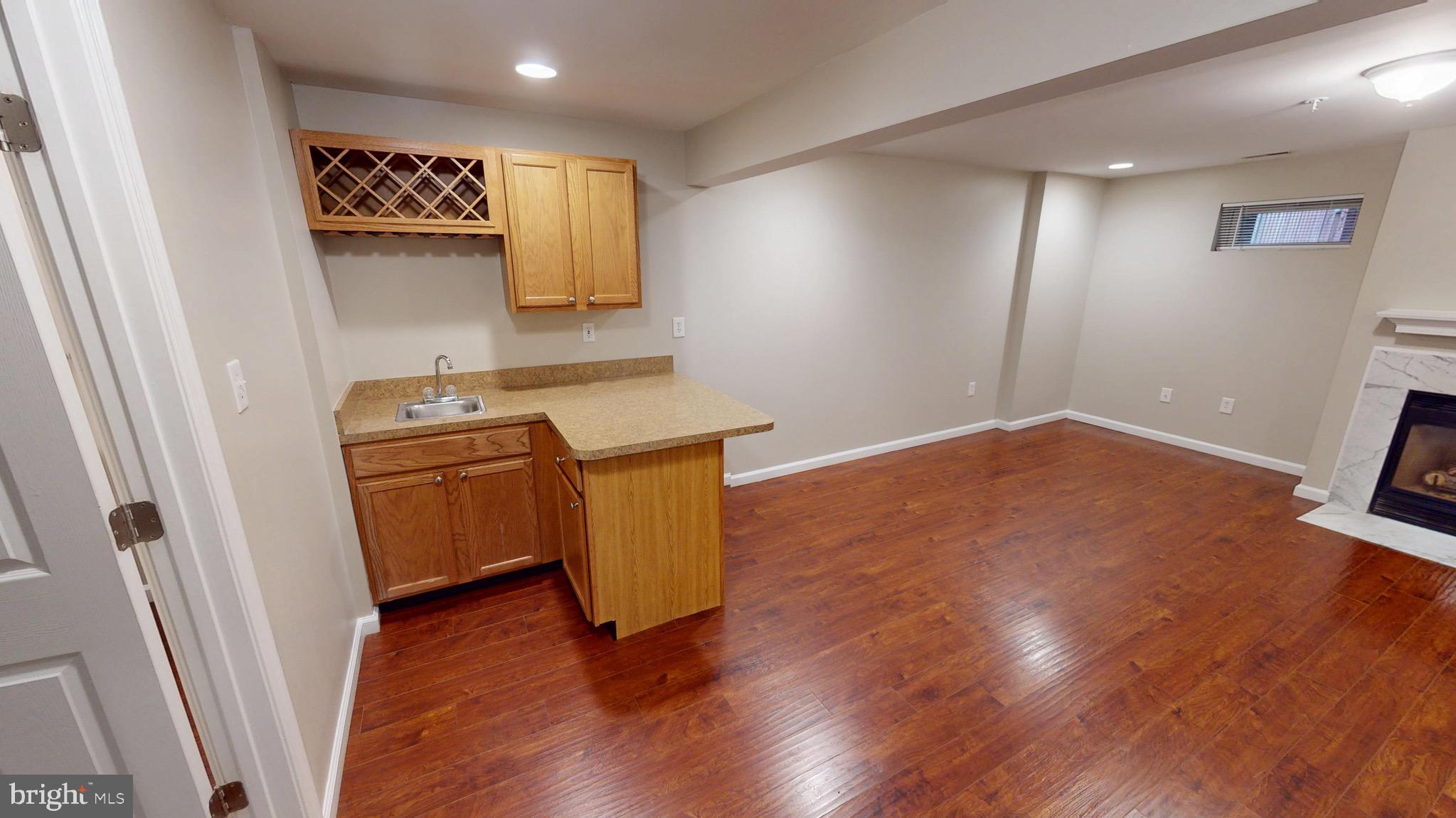 10611 Riva Place White Plains, MD 20695 - Photo 62 of 93 a view of a room with wooden floor and sink