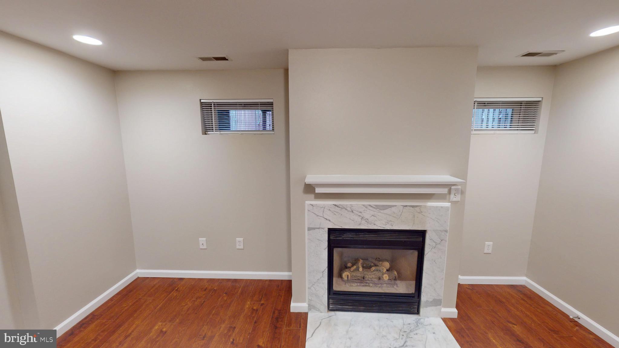 10611 Riva Place White Plains, MD 20695 - Photo 68 of 93 a view of an empty room with a fireplace
