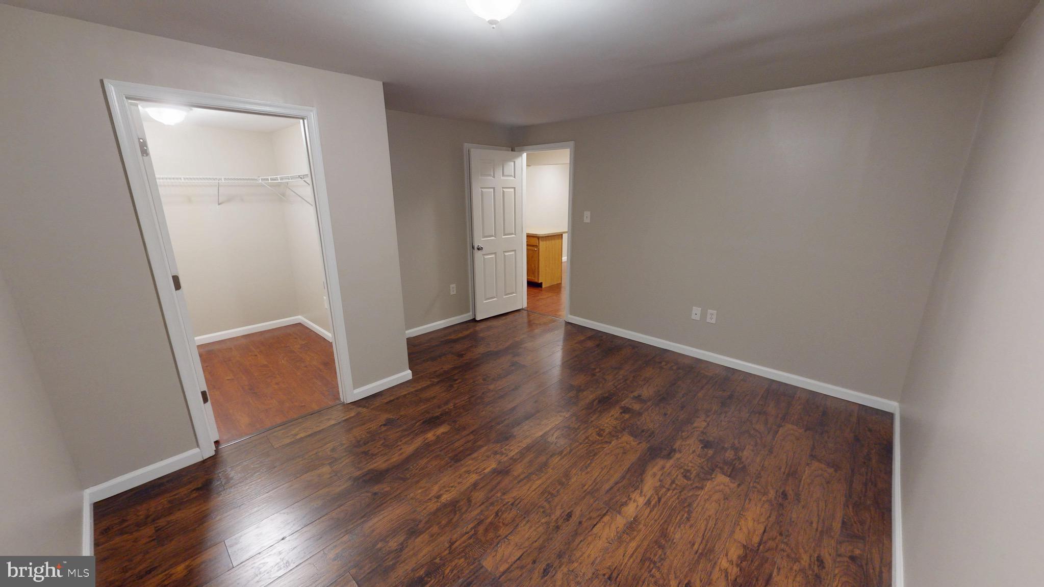 10611 Riva Place White Plains, MD 20695 - Photo 74 of 93 an empty room with wooden floor and a window
