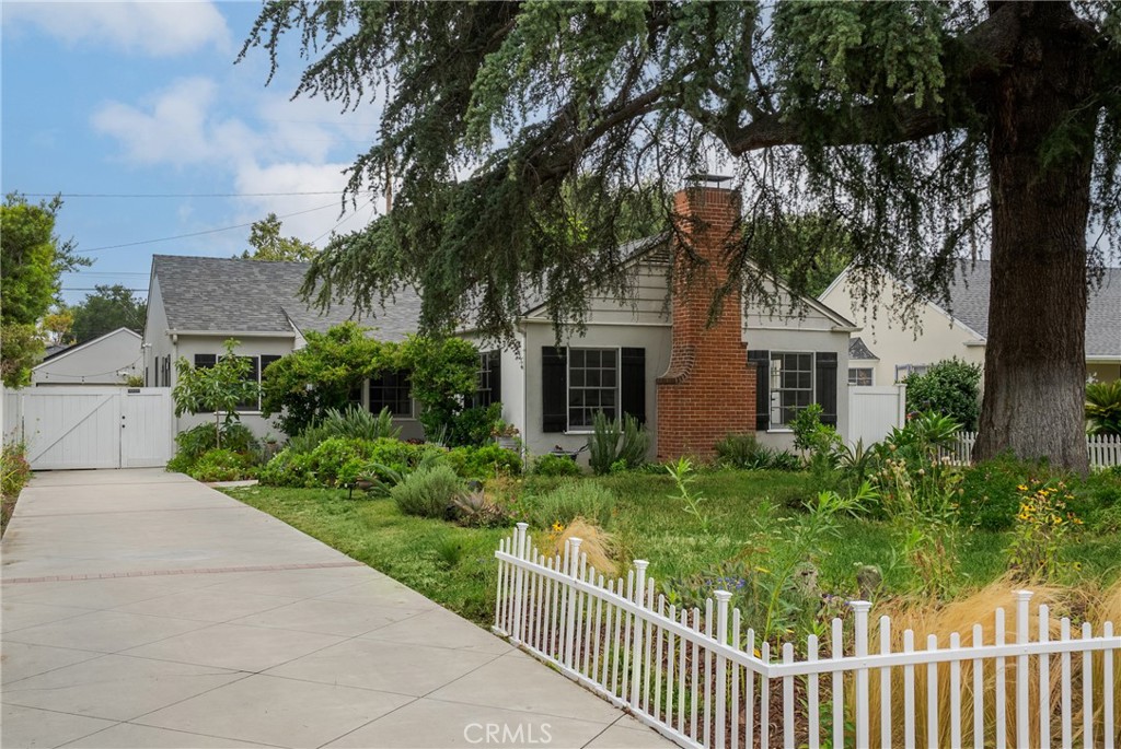 a front view of a house with yard and green space