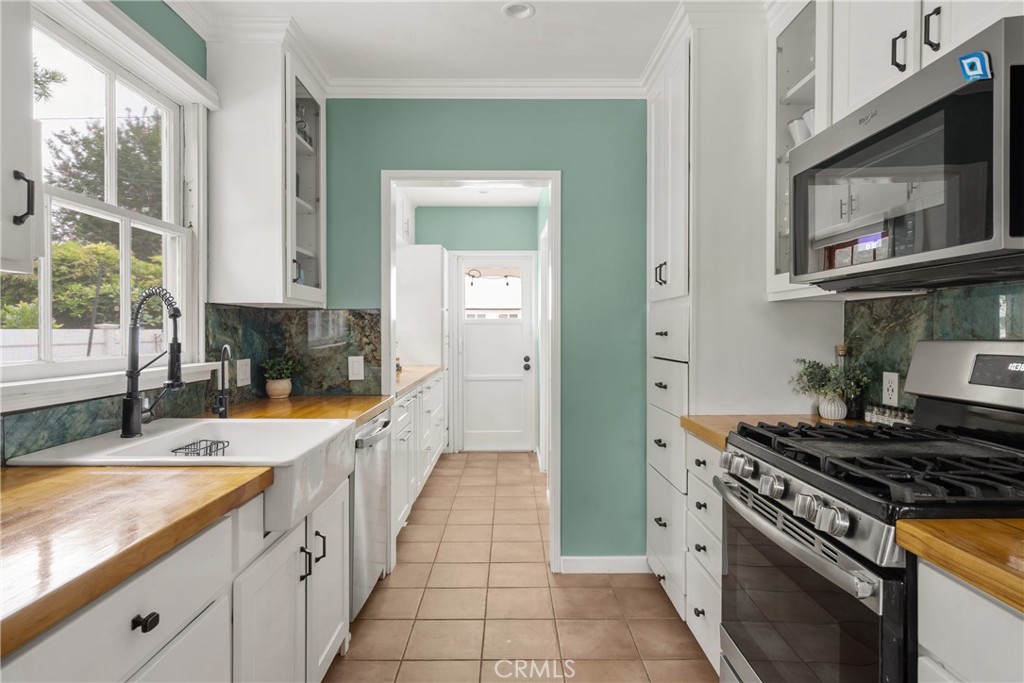 2014 North Flower Street Santa Ana, CA 92706 - Photo 14 of 28 a kitchen with granite countertop a sink stove and cabinets