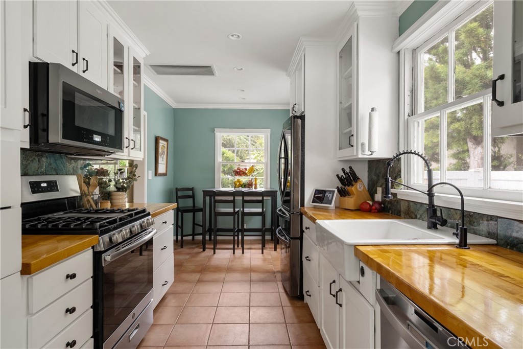 2014 North Flower Street Santa Ana, CA 92706 - Photo 15 of 28 a kitchen with stainless steel appliances granite countertop a sink and a stove