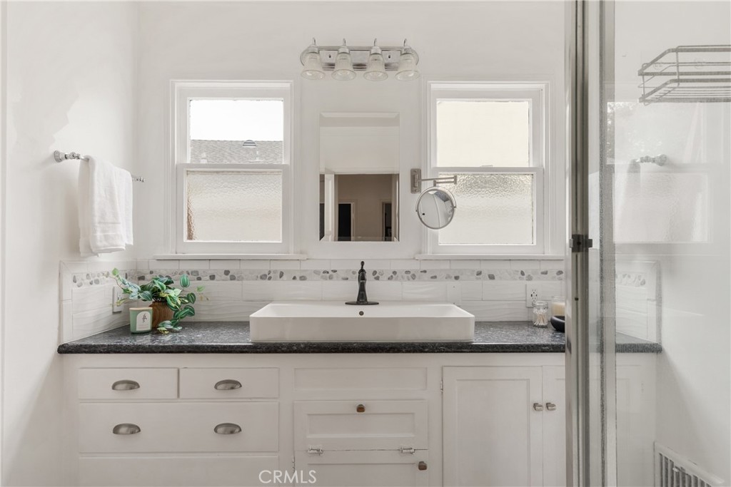 2014 North Flower Street Santa Ana, CA 92706 - Photo 19 of 28 a bathroom with a granite countertop sink and a mirror