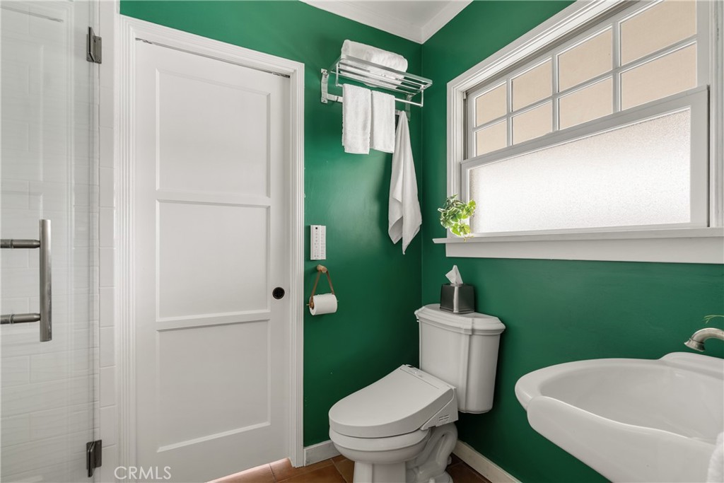 2014 North Flower Street Santa Ana, CA 92706 - Photo 23 of 28 a bathroom with a sink mirror toilet and window