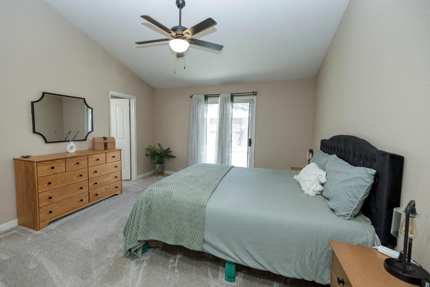 230 Meyenberg Avenue Ripon, CA 95366 - Photo 31 of 52 a bedroom with a bed and a flat screen tv