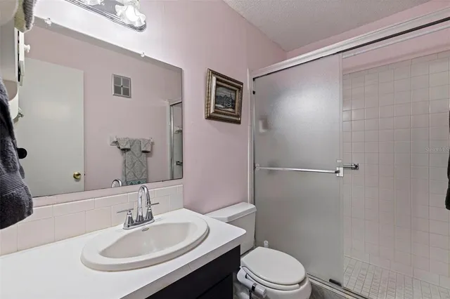 a bathroom with a sink toilet and a mirror