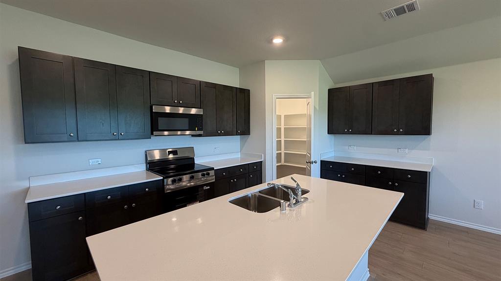 2007 Reveille Way Terrell, TX 75160 - Photo 17 of 31 a kitchen with a sink a stove and microwave