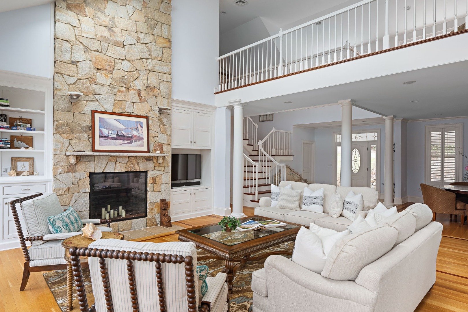 385 Barnes Road Oak Bluffs, MA 02557 - Photo 12 of 60 a living room with furniture a fireplace and a flat screen tv