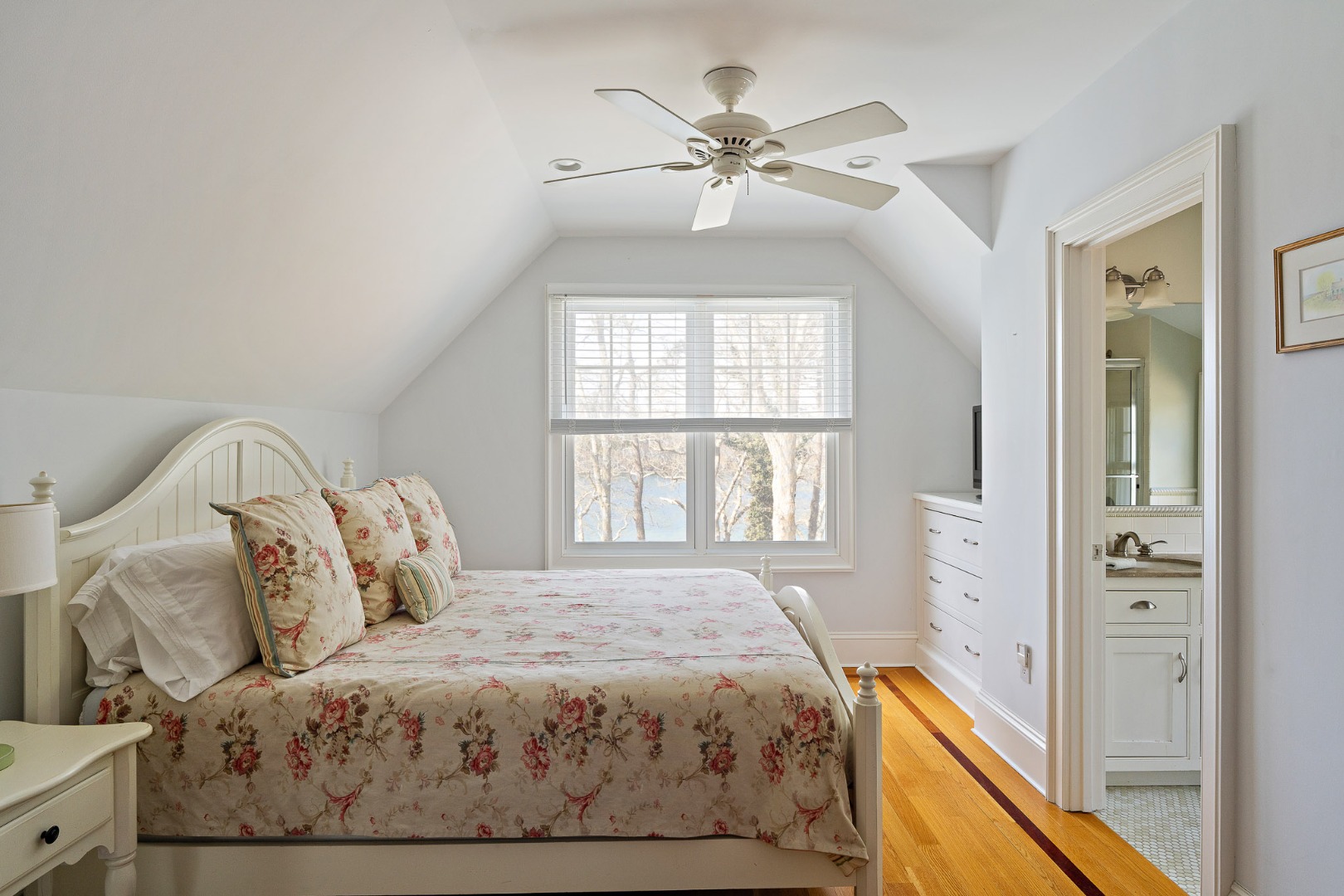 385 Barnes Road Oak Bluffs, MA 02557 - Photo 41 of 60 a bedroom with a large bed and a chandelier