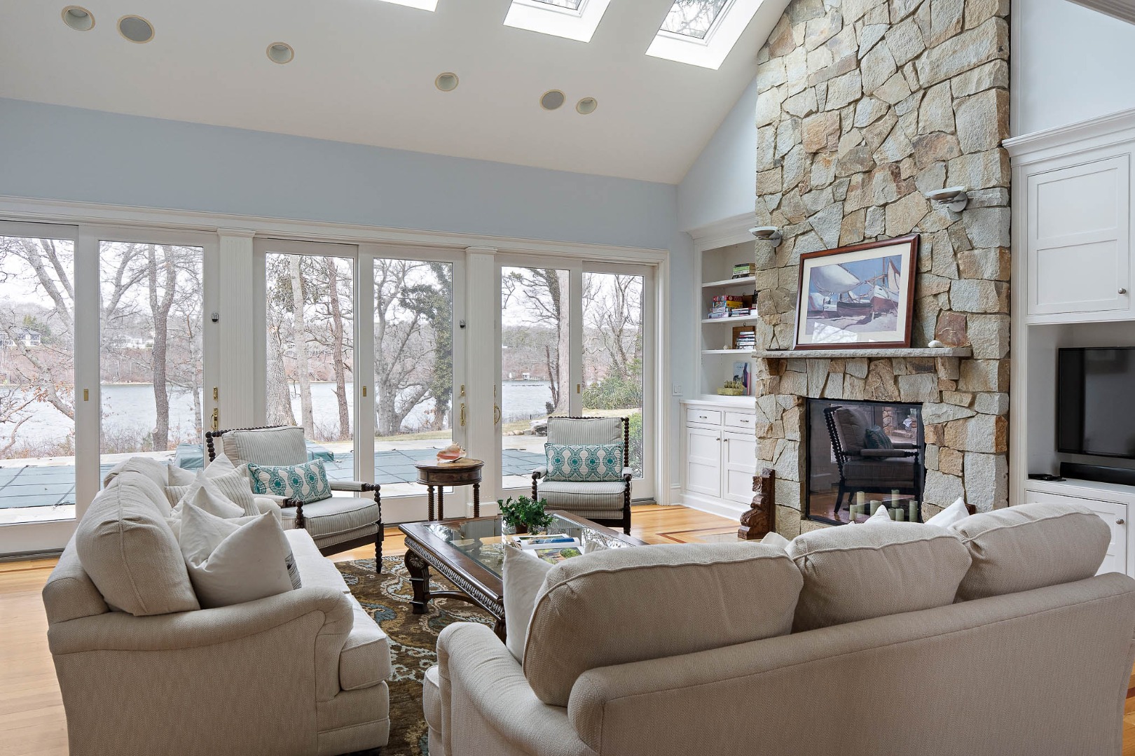 385 Barnes Road Oak Bluffs, MA 02557 - Photo 10 of 60 a living room with furniture large window and a fireplace