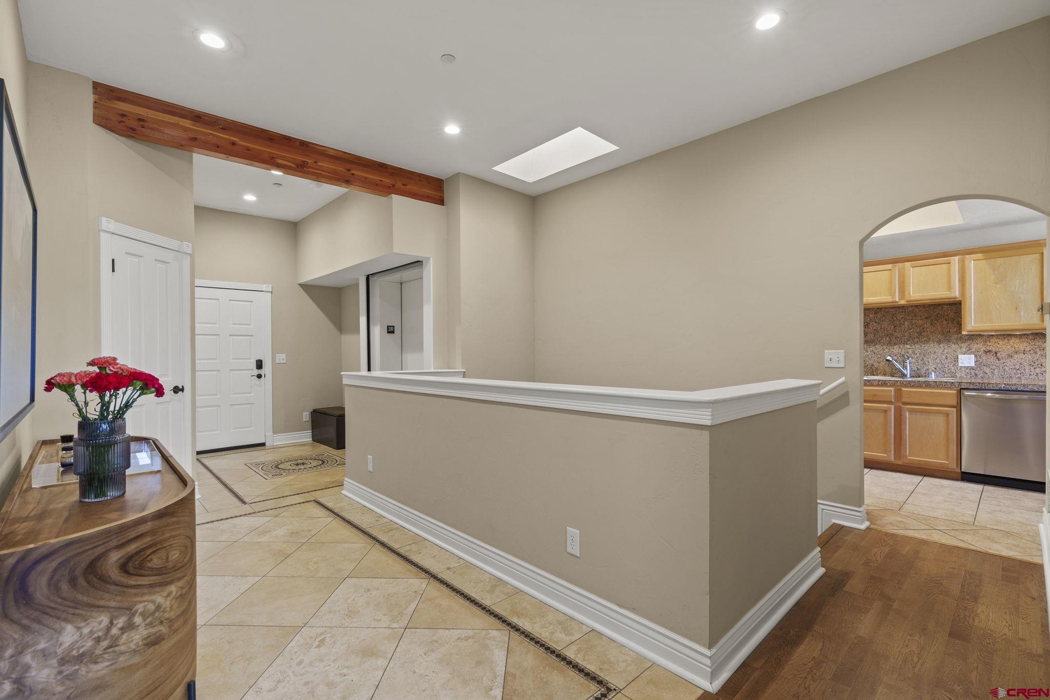 543 East 2nd Avenue, Unit 3E Durango, CO 81301 - Photo 12 of 39 a hallway with a stove a faucet and a chandelier