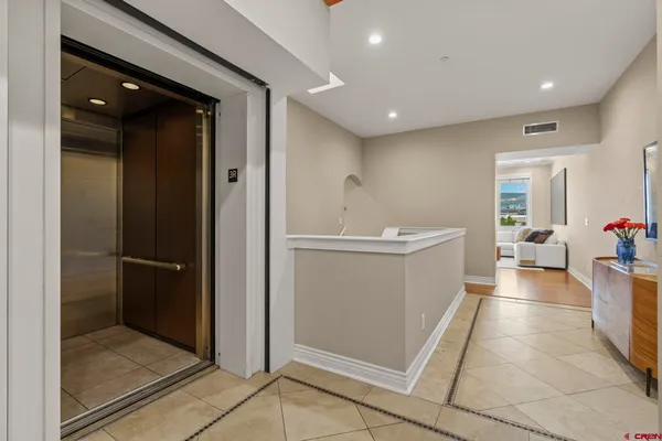 a view of a hallway with dining area