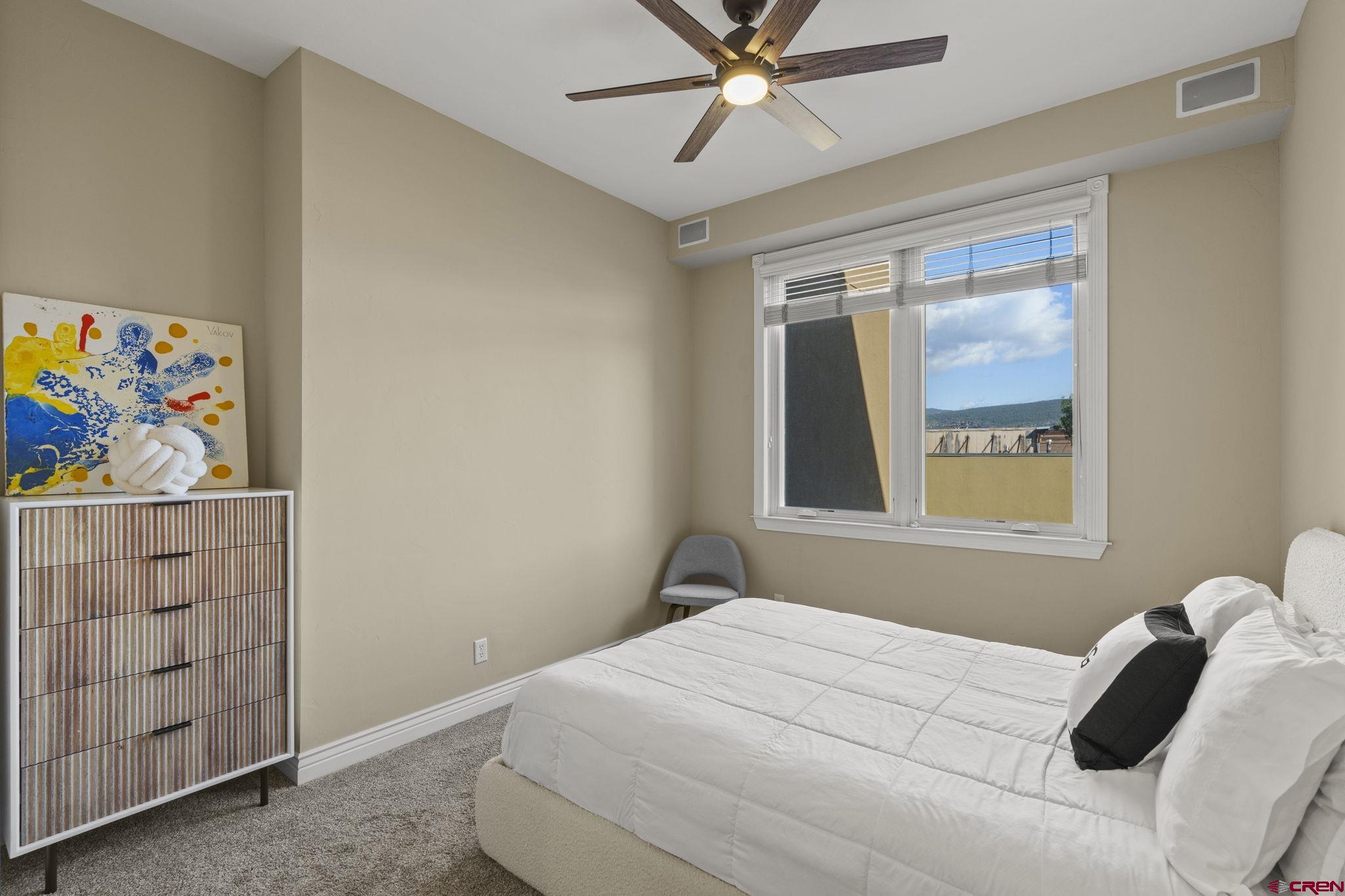 543 East 2nd Avenue, Unit 3E Durango, CO 81301 - Photo 16 of 39 a bedroom with a bed and a window