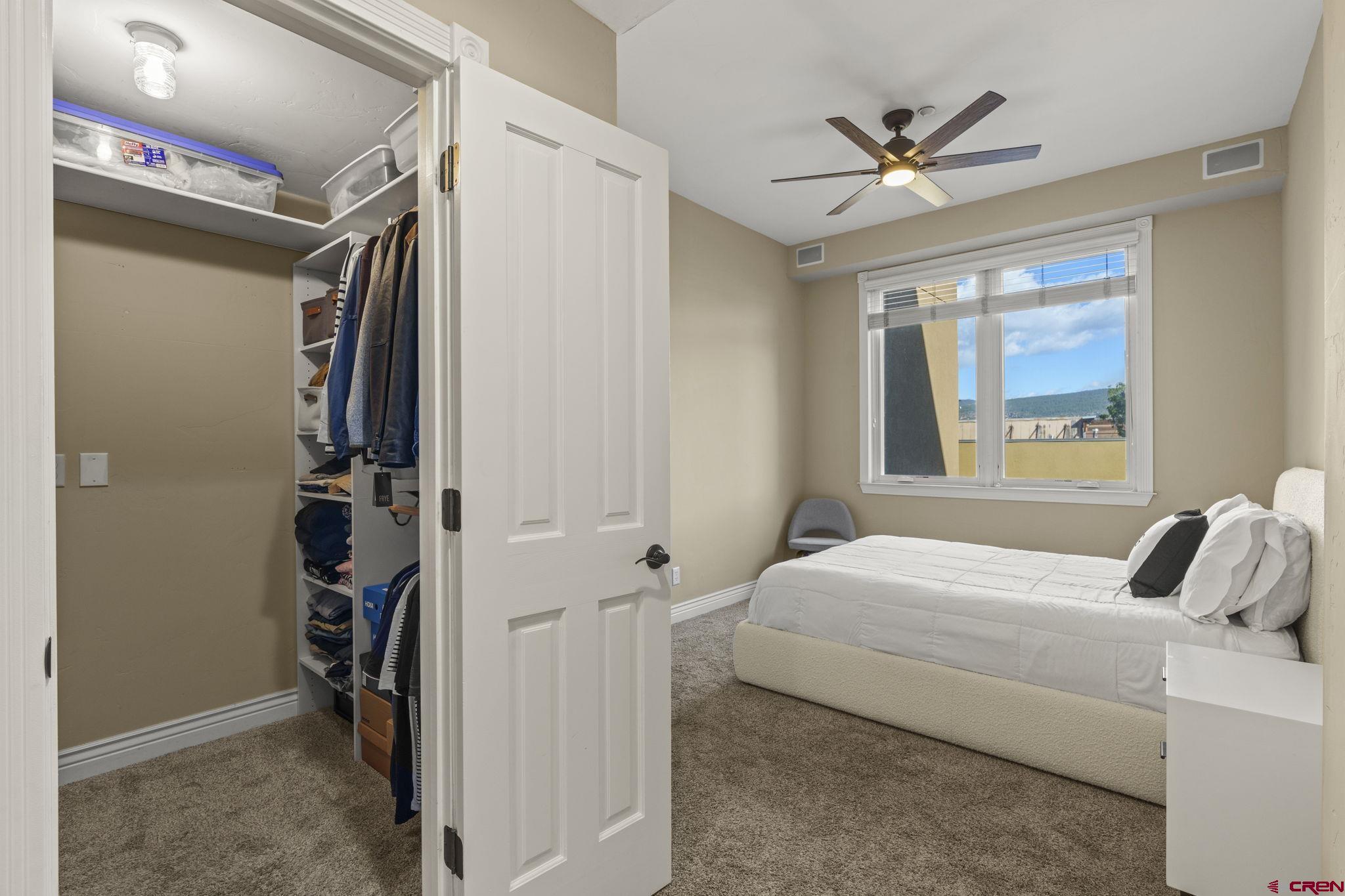 543 East 2nd Avenue, Unit 3E Durango, CO 81301 - Photo 18 of 39 a bedroom with a bed and a chandelier