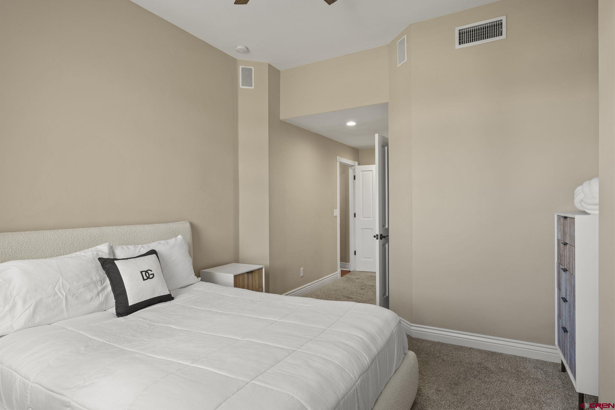 543 East 2nd Avenue, Unit 3E Durango, CO 81301 - Photo 22 of 39 a bedroom with a bed and a refrigerator