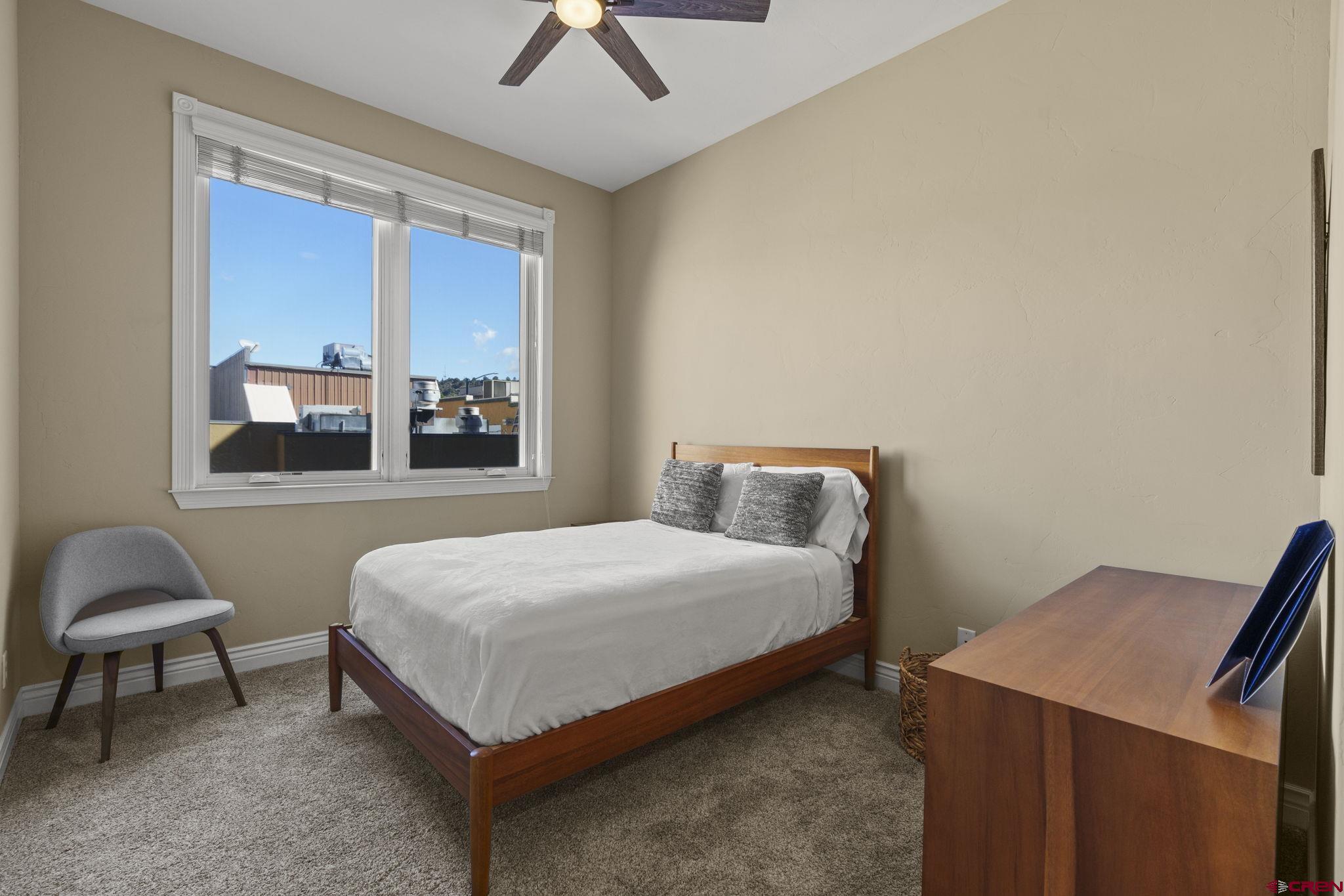 543 East 2nd Avenue, Unit 3E Durango, CO 81301 - Photo 27 of 39 a bedroom with a bed and a window