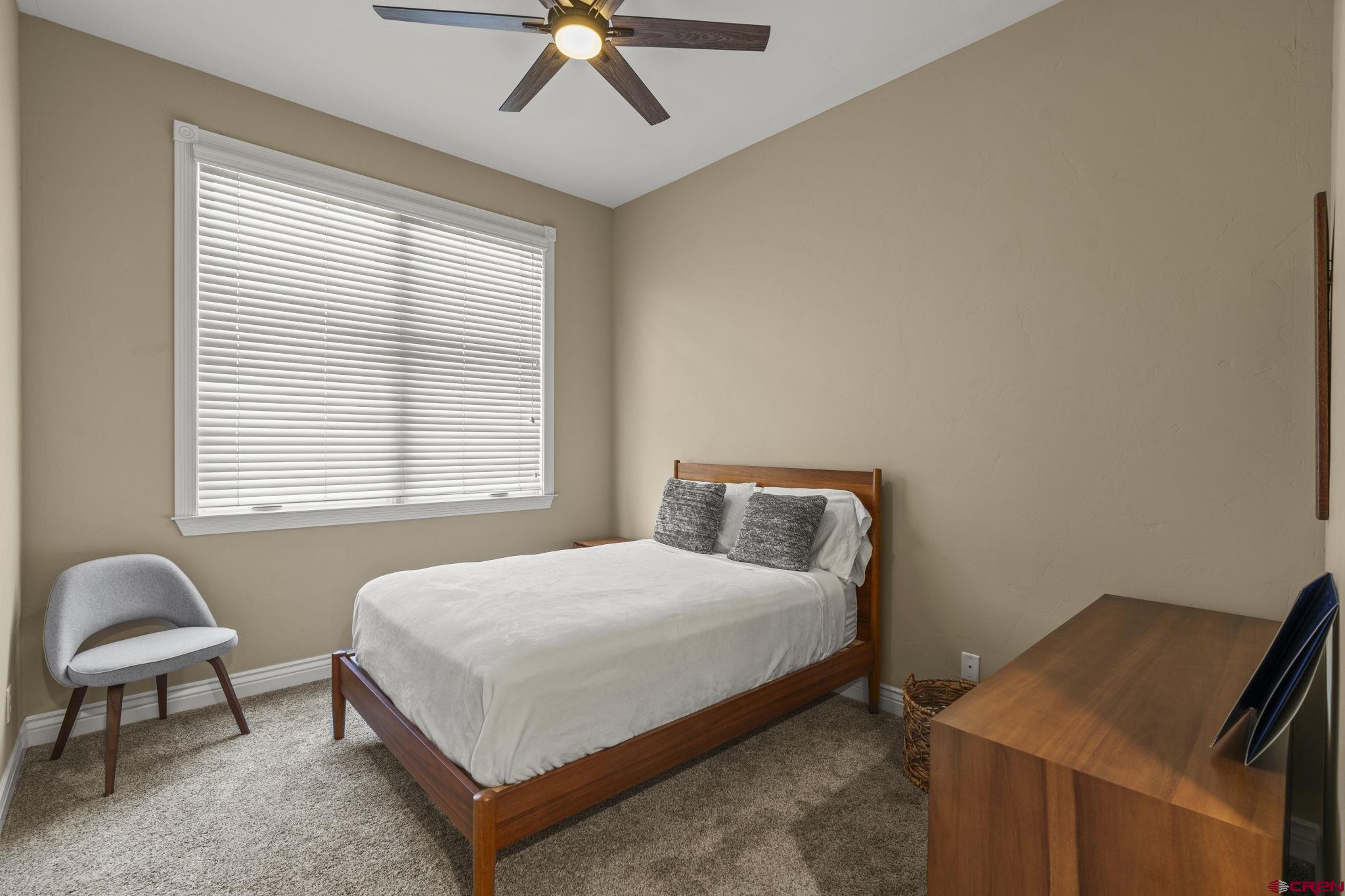 543 East 2nd Avenue, Unit 3E Durango, CO 81301 - Photo 28 of 39 a bedroom with a bed and a chandelier