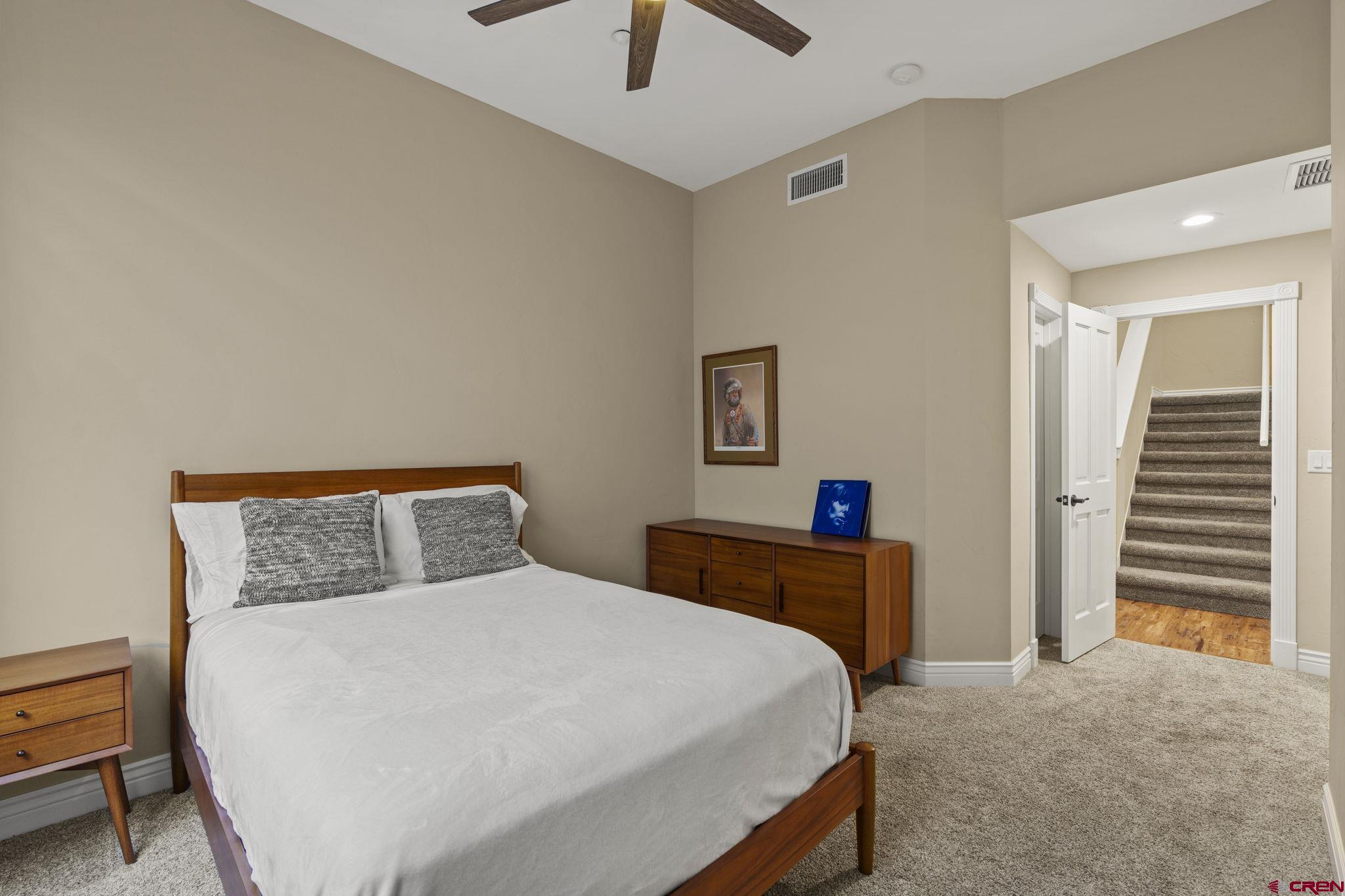 543 East 2nd Avenue, Unit 3E Durango, CO 81301 - Photo 29 of 39 a bedroom with a bed and a chandelier