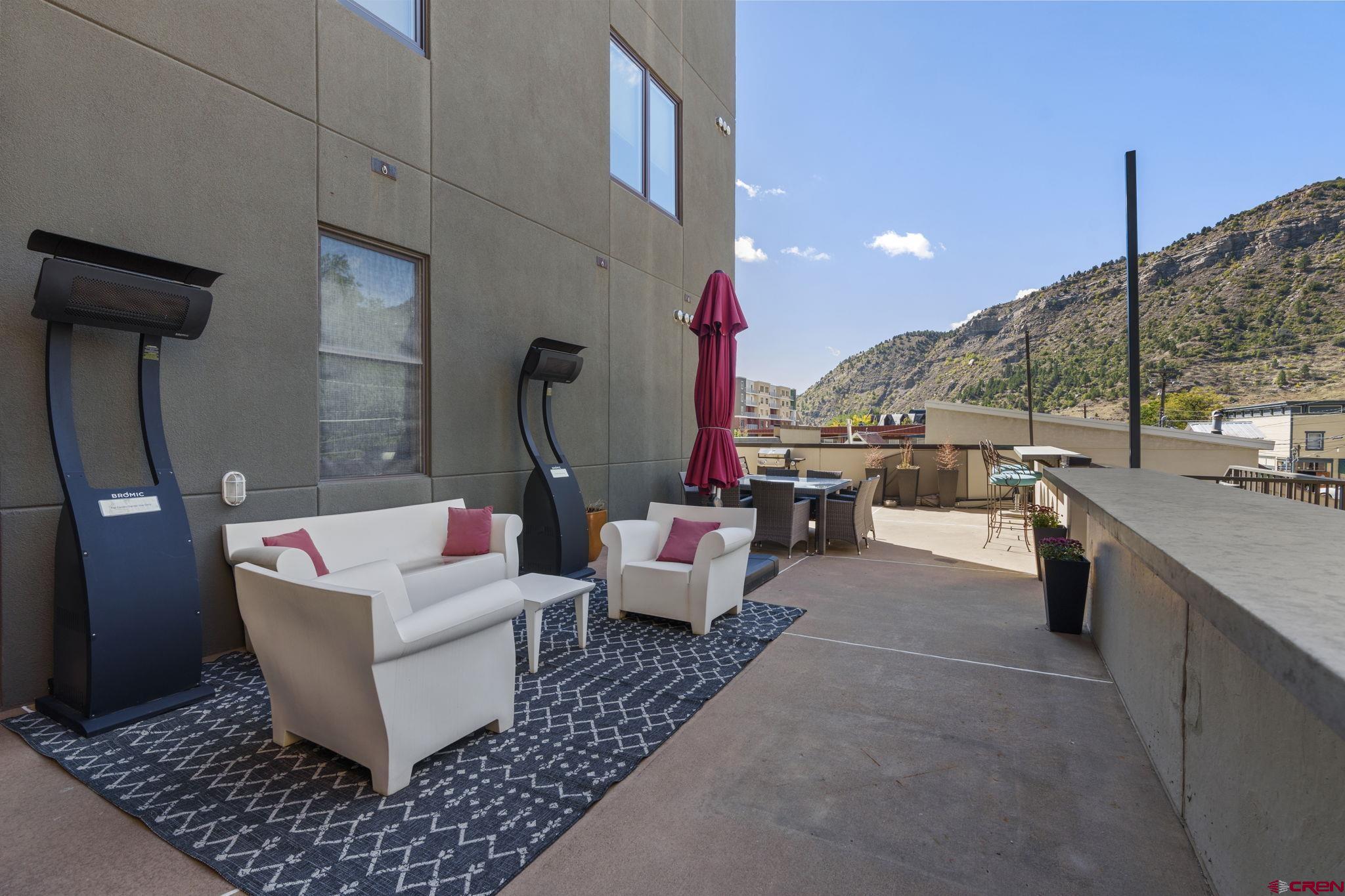 543 East 2nd Avenue, Unit 3E Durango, CO 81301 - Photo 32 of 39 a living room with couches and kitchen view with wooden floor