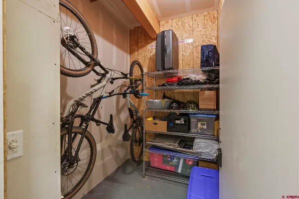 a view of walk in closet with clothes