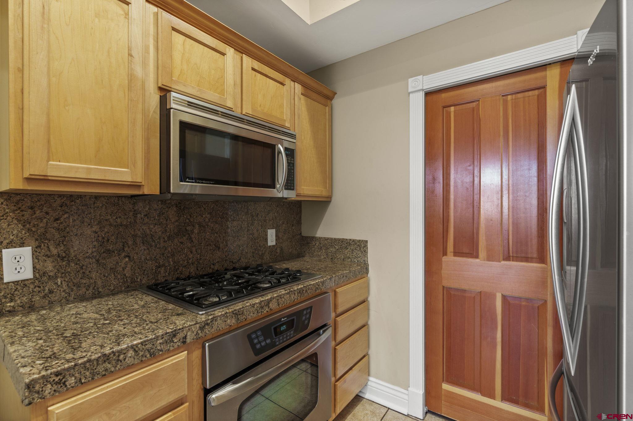 543 East 2nd Avenue, Unit 3E Durango, CO 81301 - Photo 9 of 39 a kitchen with granite countertop cabinets stainless steel appliances and a window