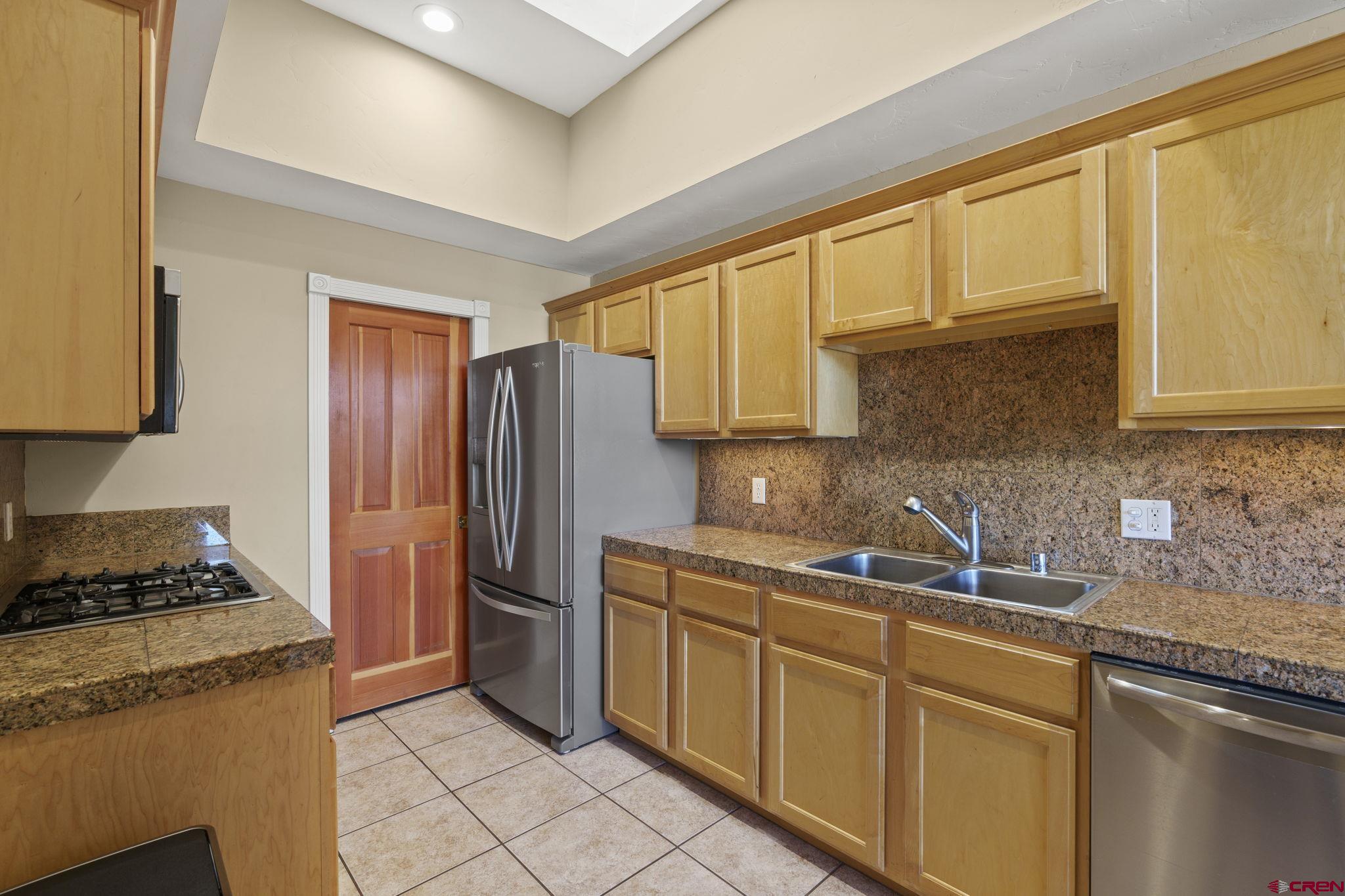 543 East 2nd Avenue, Unit 3E Durango, CO 81301 - Photo 10 of 39 a kitchen with stainless steel appliances granite countertop a sink stove and refrigerator