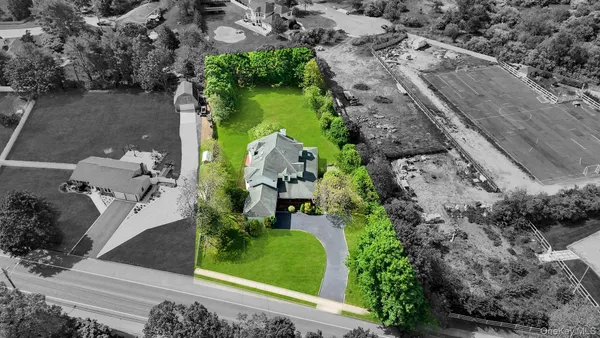 an aerial view of a house with a yard