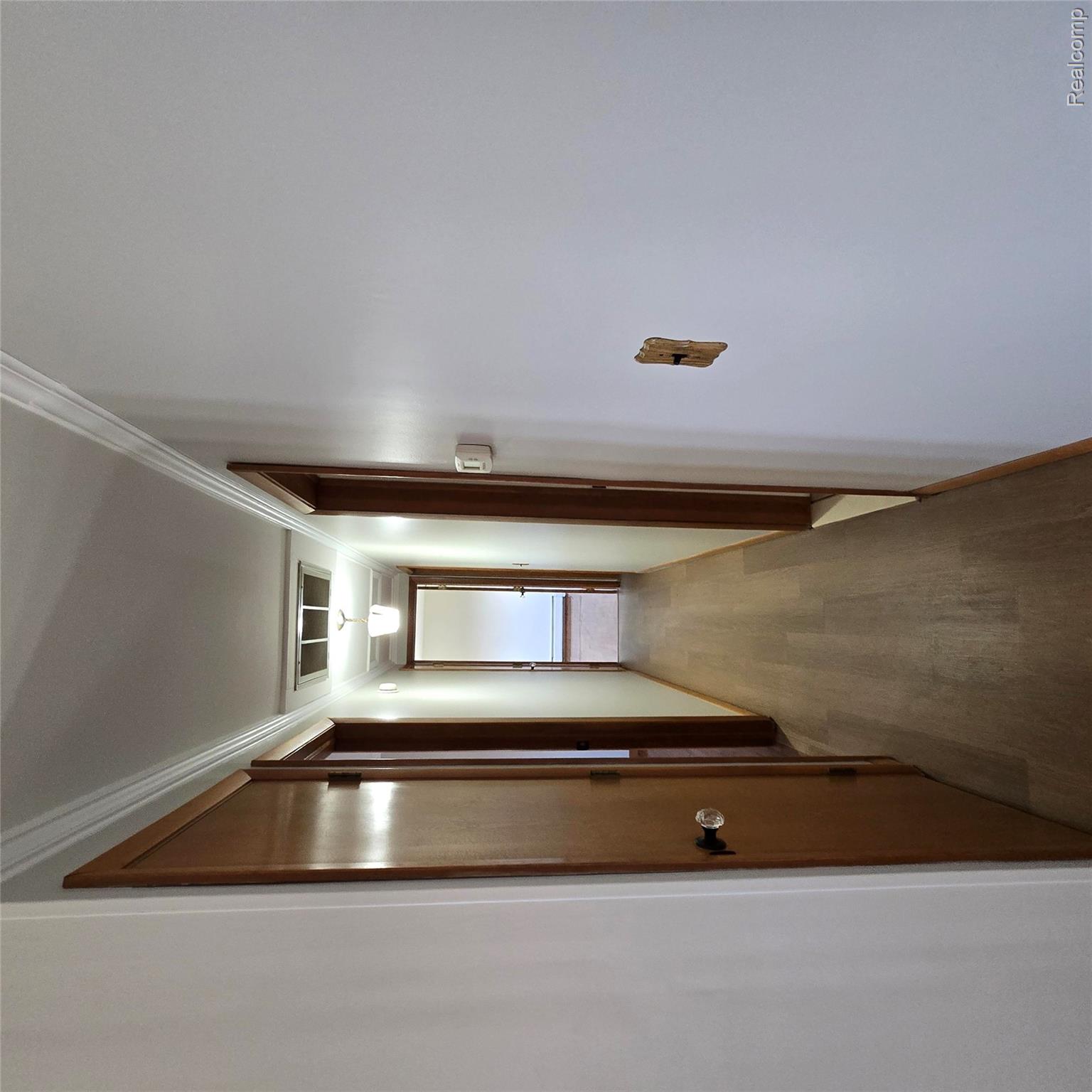311 Nevada Avenue Rochester, MI 48309 - Photo 28 of 70 Hallway featuring wood-finish flooring, white walls, and wood doors