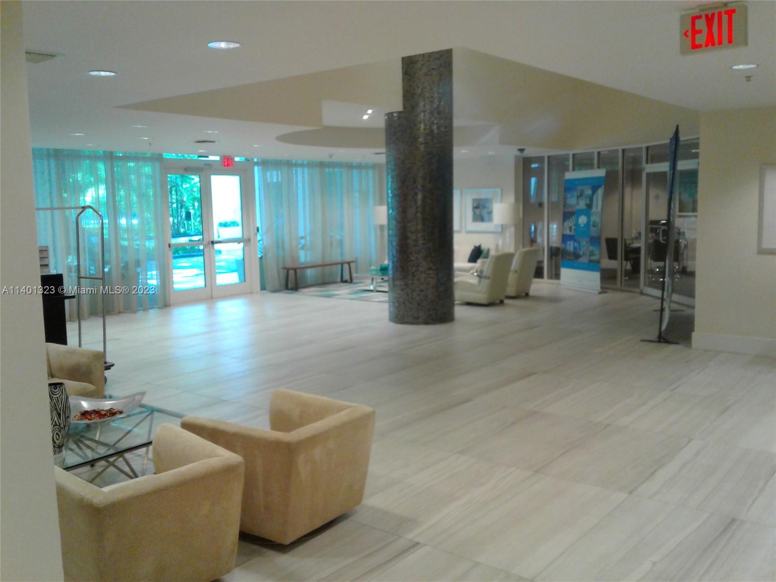 a lobby with furniture and window