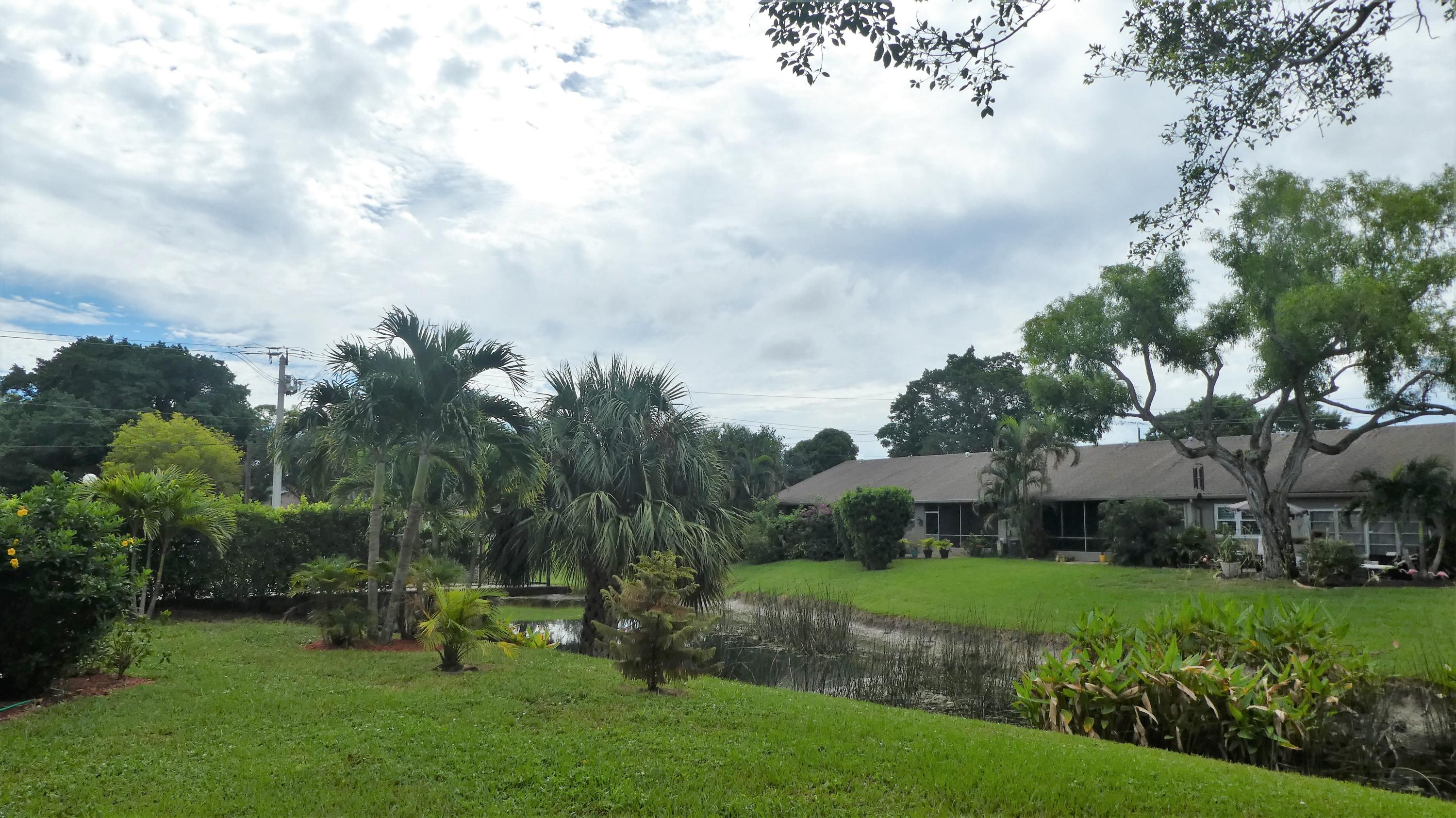 2500 Fiore Way, Unit 102C Delray Beach, FL 33445 - Photo 15 of 33 a view of a garden with houses