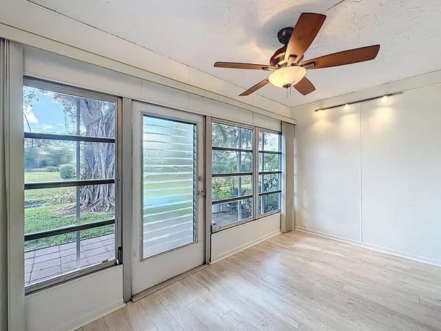 a kitchen with stainless steel appliances granite countertop a refrigerator a sink and white cabinets
