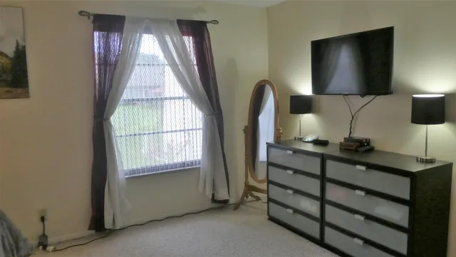 a room with two chair and a flat screen tv