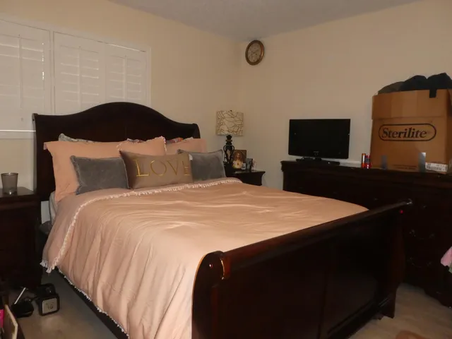 a bedroom with a bed and a television