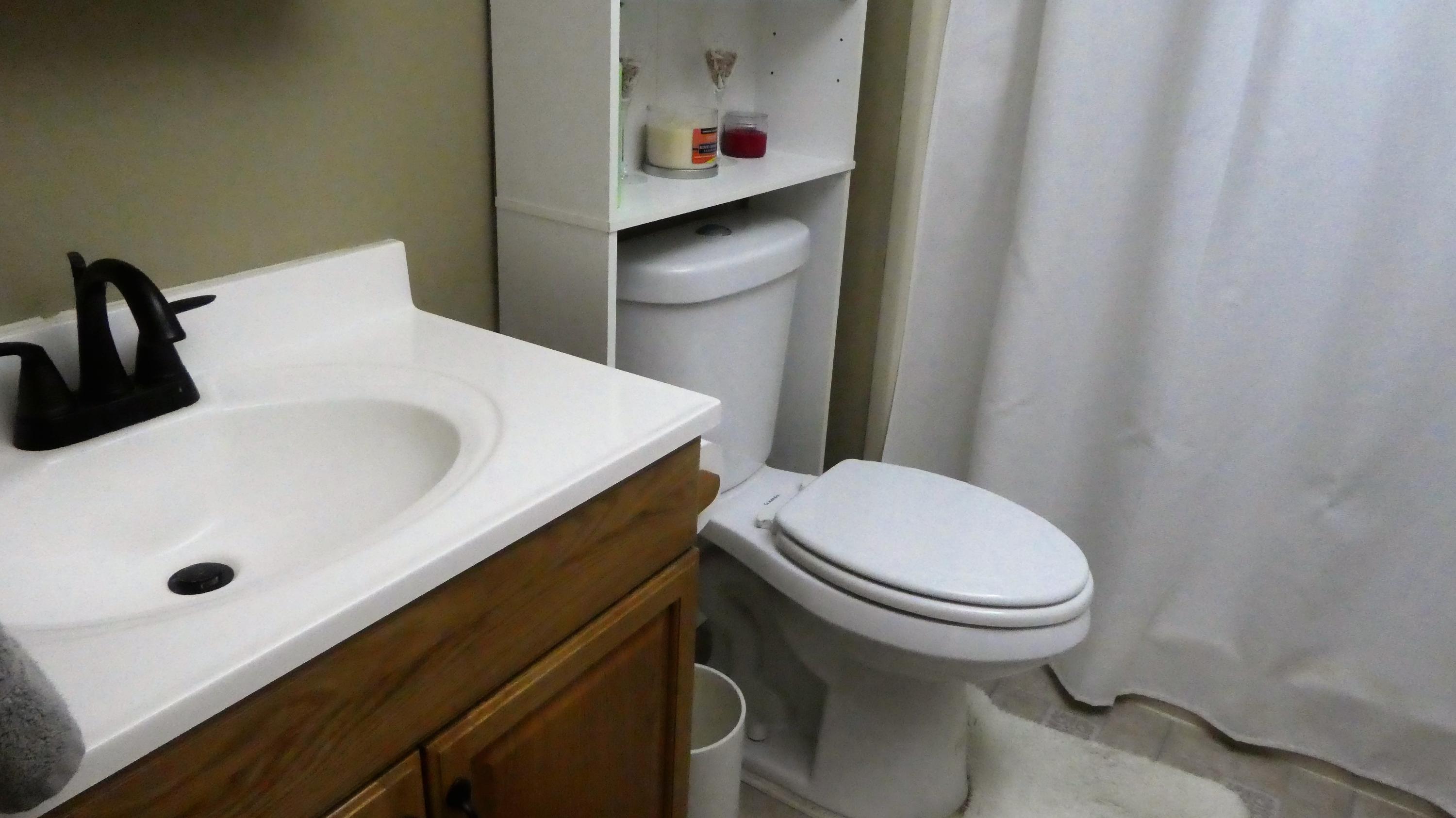 2500 Fiore Way, Unit 102C Delray Beach, FL 33445 - Photo 23 of 33 a bathroom with a sink a toilet and shower curtain