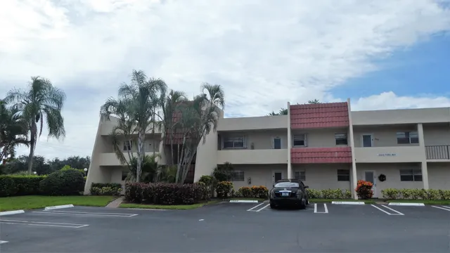 a couple of cars parked in front of a house