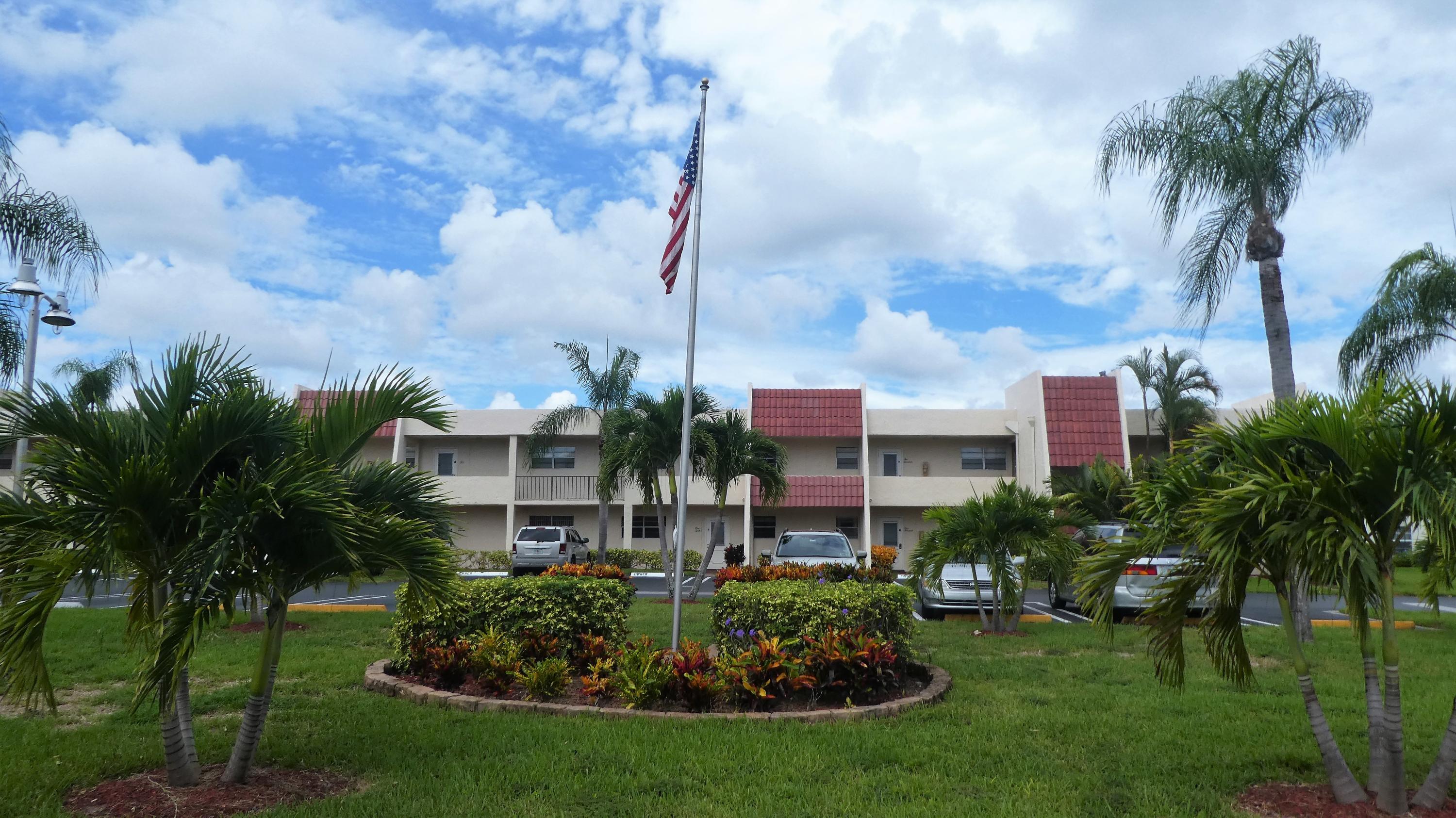 2500 Fiore Way, Unit 102C Delray Beach, FL 33445 - Photo 29 of 33 a front view of a house with a garden