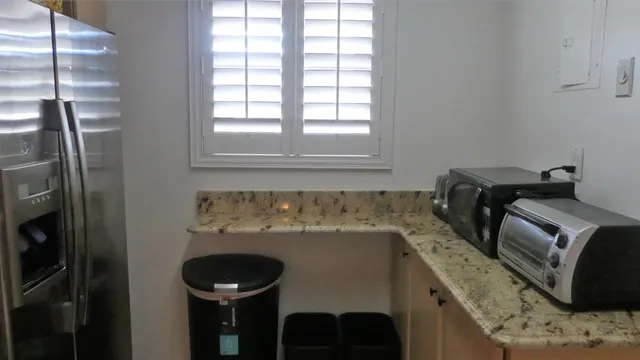 a close view of a sink and a refrigerator in a kitchen