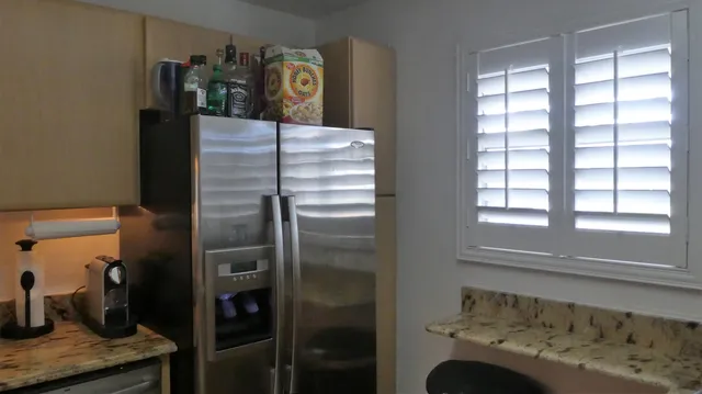 a kitchen with a refrigerator and window