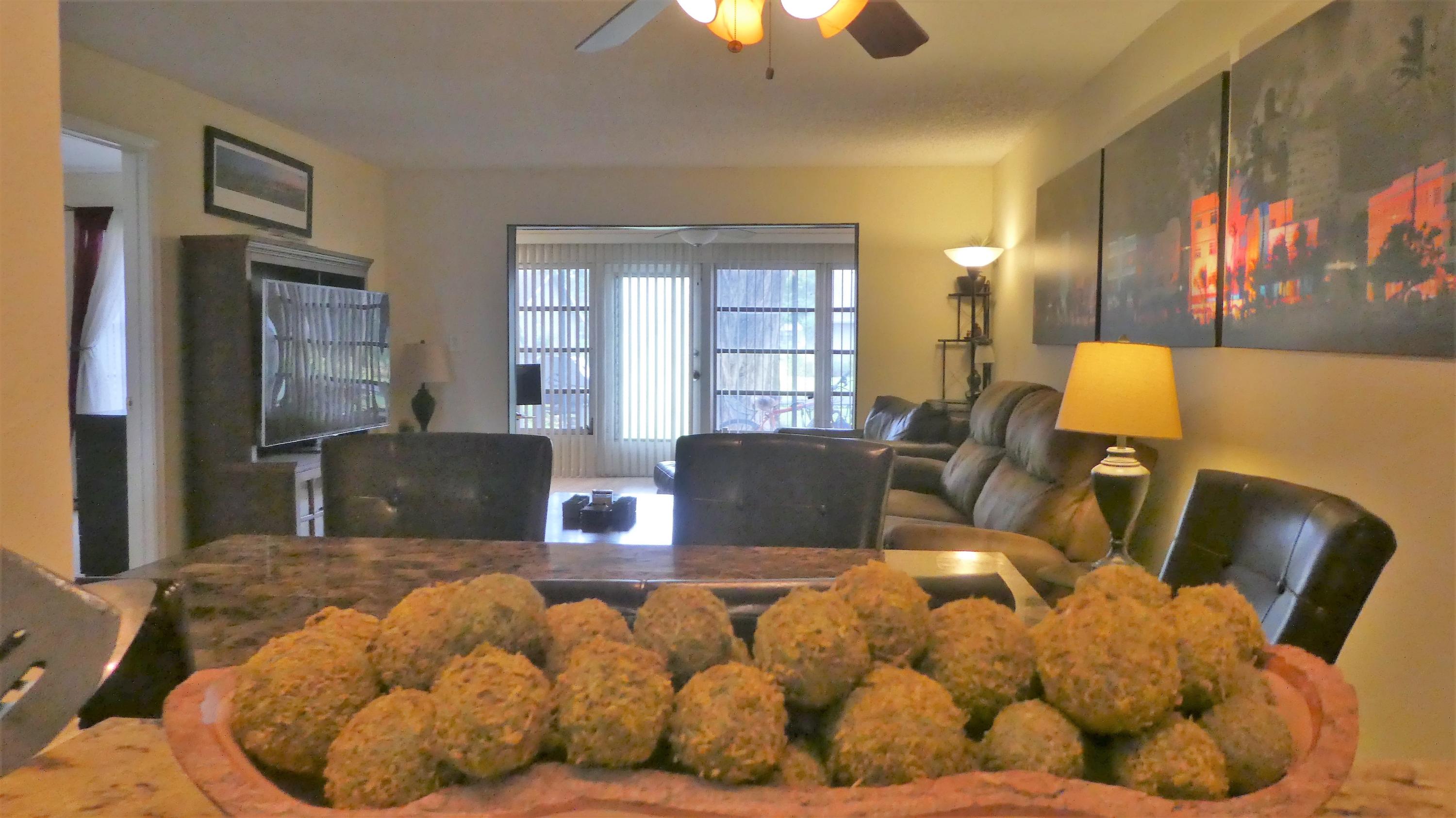 2500 Fiore Way, Unit 102C Delray Beach, FL 33445 - Photo 6 of 33 a bed room with a bed and a couch