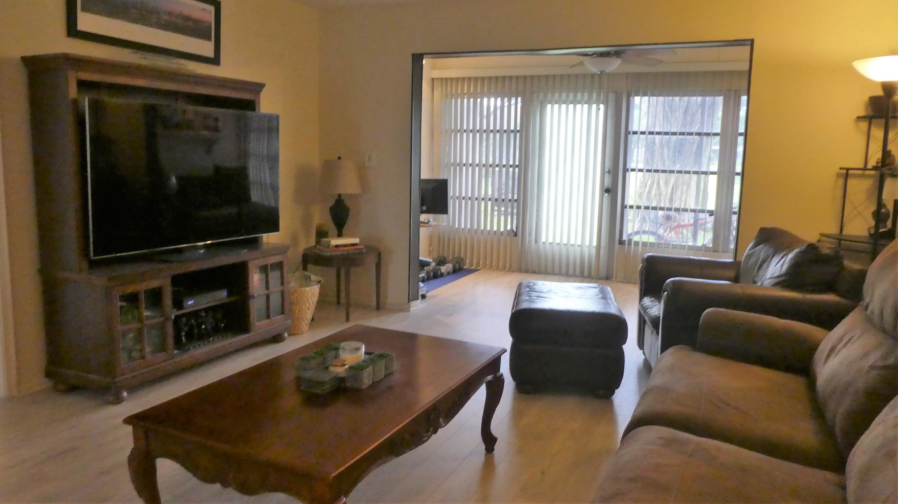 2500 Fiore Way, Unit 102C Delray Beach, FL 33445 - Photo 10 of 33 a living room with furniture and a flat screen tv