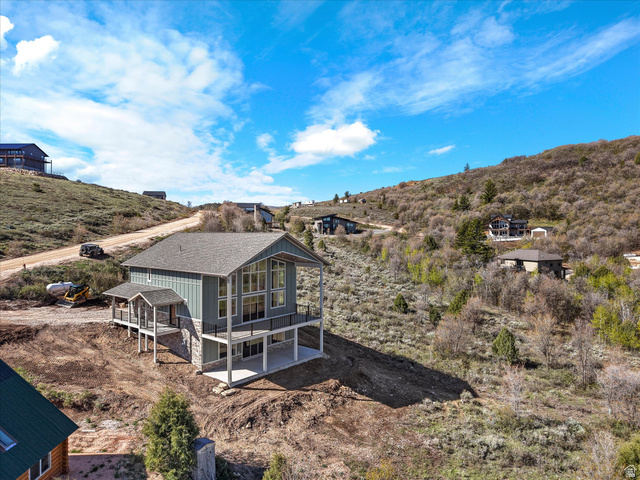 1159 North Broad Hollow Road Garden City, UT 84028 - Photo 18 of 55 Contemporary multi-level residence featuring a gray shingle roof, vertical siding, and a stone facade