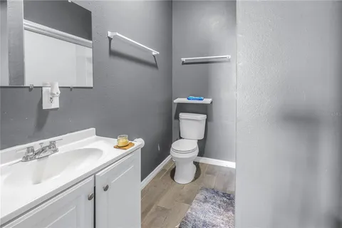 a bathroom with a sink toilet and vanity