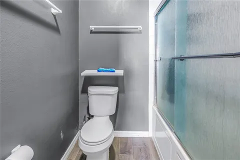 a bathroom with a toilet and a shower