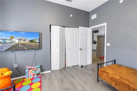 a bedroom with bed and gym equipment