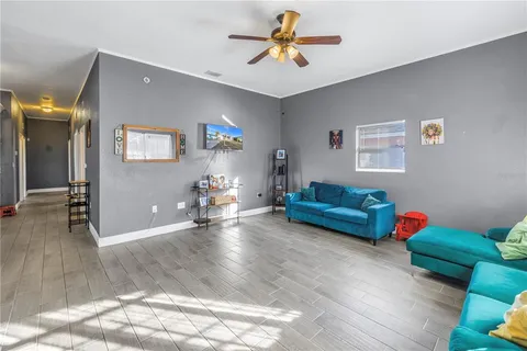 a living room with furniture and wooden floor